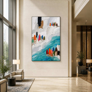 Vertical turquoise coastal wall art displayed in a bright hotel lobby.