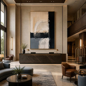 Gold-framed Where Day Meets Night above a dark reception counter in a spacious hotel lobby.