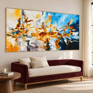 Angled abstract above a burgundy settee with cream cushions.