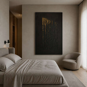 Black and gold abstract painting styled in a soft neutral bedroom.
