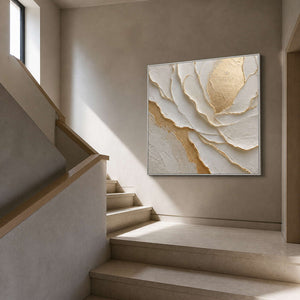 Ivory and gold artwork viewed beside a warm gray residential staircase.
