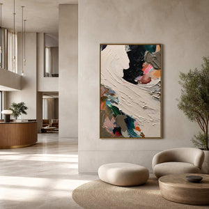 Vertical abstract painting displayed in a spacious modern hotel lobby.