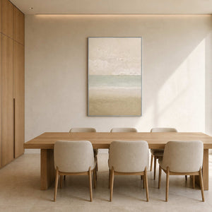 Soft coastal canvas displayed above a refined light wood dining table.