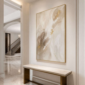 Vertical neutral abstract wall art in an elegant entryway.