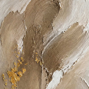 Close-up of raised taupe, ivory, stone, and gold plaster-like texture.