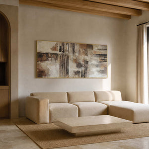 Textured abstract wall art displayed in a warm hotel suite lounge.