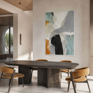 Architectural abstract artwork above a dark contemporary dining table.