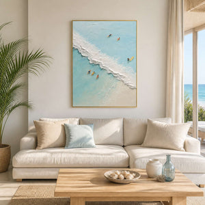 Aerial beach wall art displayed in a warm white coastal living room.