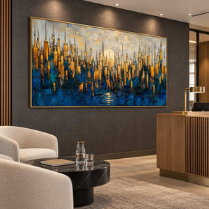 Blue and golden cityscape on a dark wall above pale seating in a reception area.