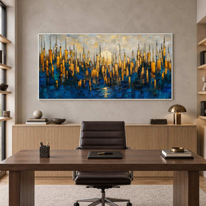 Abstract skyline painting behind a wood desk and dark office chair in a bright study.