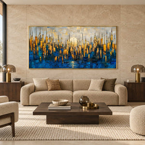 Blue and gold-toned skyline painting above a curved cream sofa with twin table lamps.