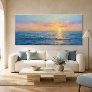 Textured sunset ocean wall art displayed in a bright coastal living room.