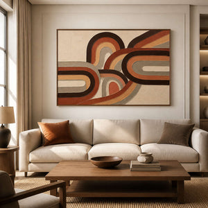 Warm textured boho wall art displayed above a neutral living room sofa.
