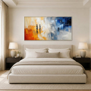 Wide orange, ivory, and blue abstract canvas above a serene neutral bedroom.