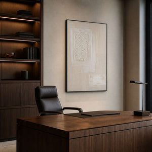 Layered neutral wall art displayed in a warm modern office.