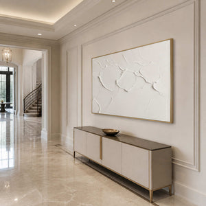 Sculptural white abstract wall art displayed in an elegant luxury entryway.
