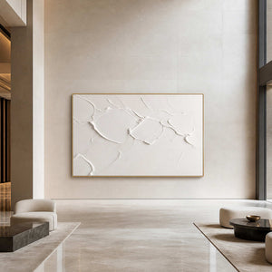 Textured white Wabi Sabi wall art displayed in an upscale hotel lobby.