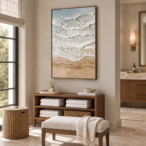 Whispering Tides in a wood frame above towel storage and a cushioned bench in a bathroom dry area.