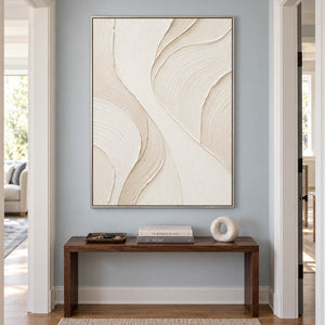 Hand-painted ivory abstract wall art with flowing cream relief and fine combed texture, displayed in a hallway in a silver frame.