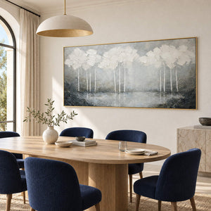 Hand-painted textured landscape wall art in white, pearl gray, and charcoal, displayed in a dining room in a gold frame.