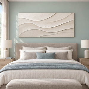 Layered ivory and warm beige relief flowing in quiet panoramic waves, displayed in a bedroom without an outer frame.