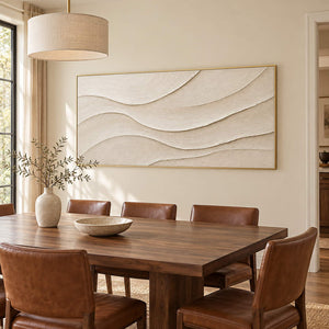 Layered ivory and warm beige relief flowing in quiet panoramic waves, displayed in a dining room in a gold frame.