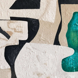 Close detail of textured cream curves meeting black shapes and a vivid green patch.