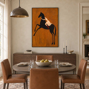 Wild at Heart in a black frame above a sideboard behind a round dining table with brown leather chairs.