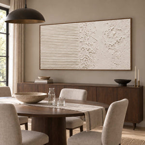 Wordless Dialogue in a wood frame above a sideboard beside a dark oval dining table and neutral upholstered chairs.