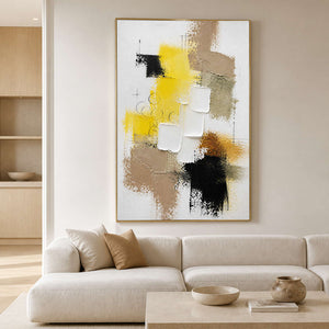 Yellow textured abstract wall art displayed above a warm neutral living room sofa.