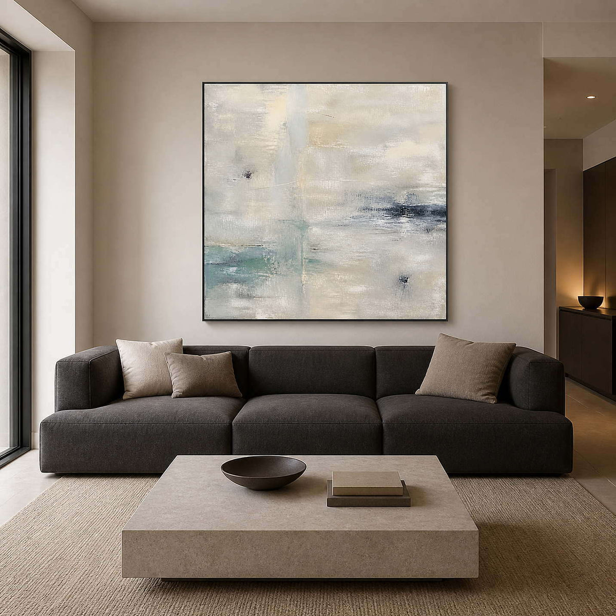 Pale neutral abstract wall art above a charcoal living room sofa.