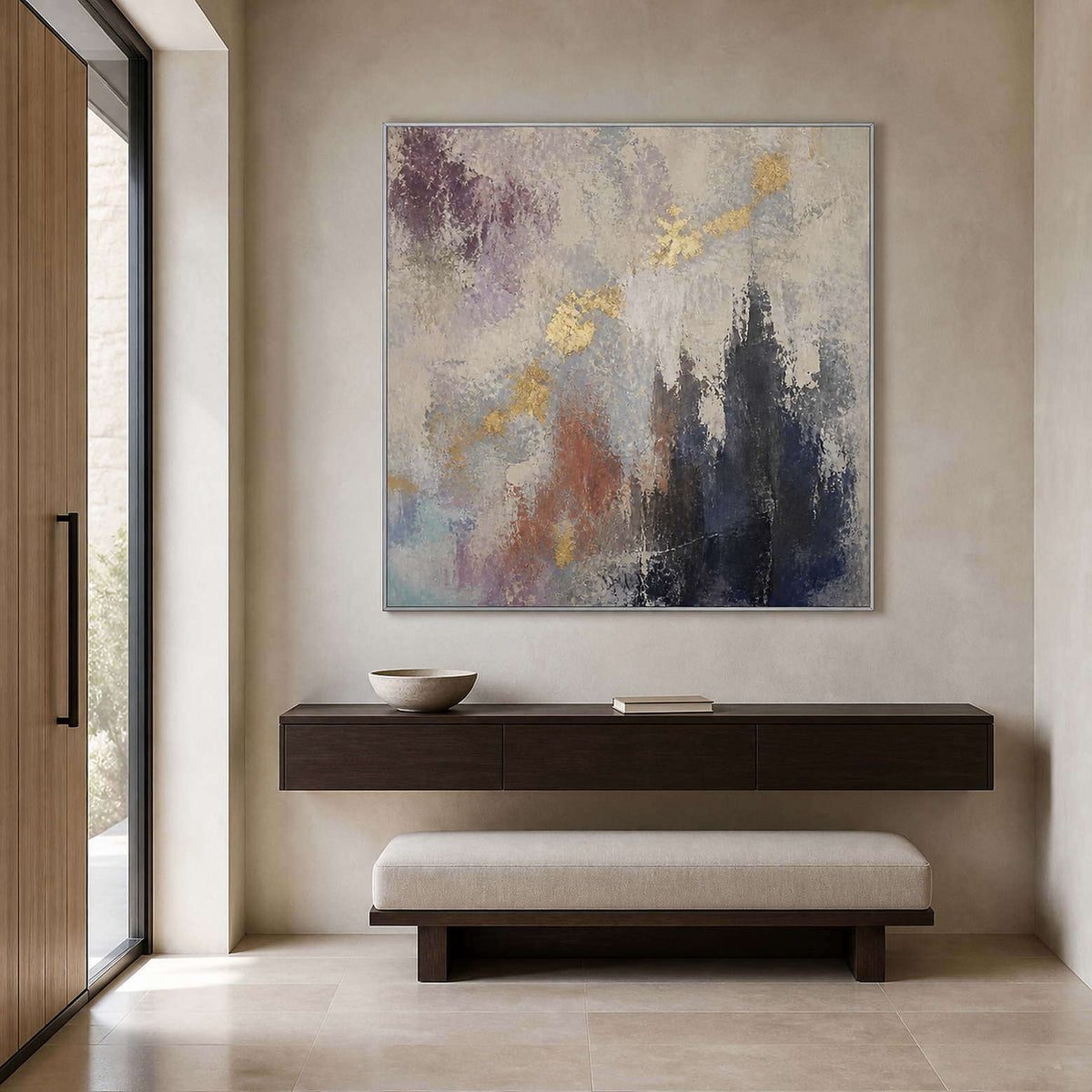 Gray and gold textured abstract wall art in a bright entryway.