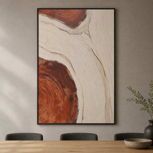 Black framed organic abstract artwork above a wooden dining table with dark chairs.