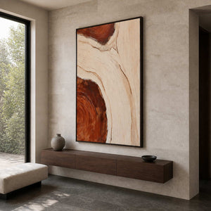 Black framed textured abstract artwork above a floating walnut console in an entryway.