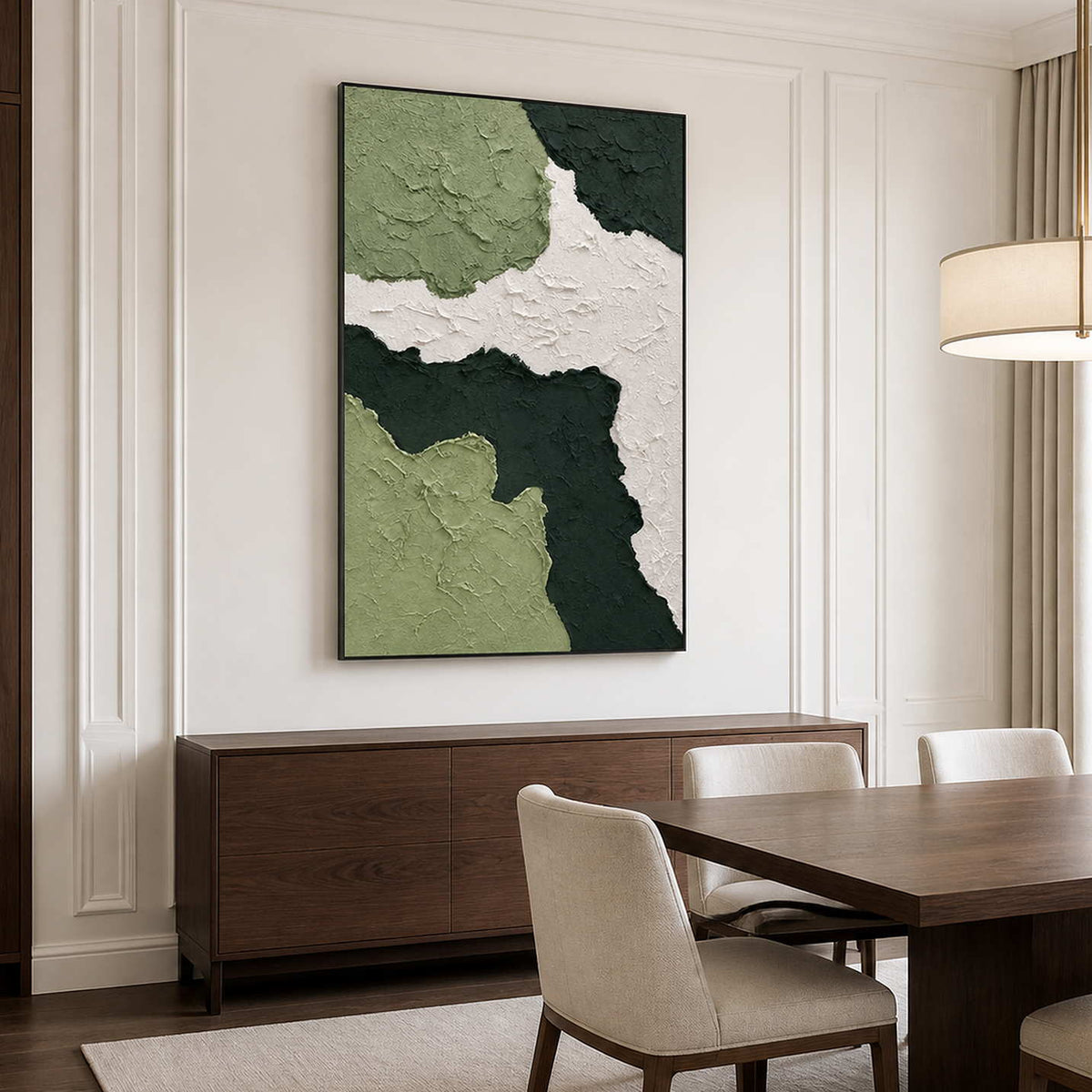 Black framed green abstract artwork above a walnut sideboard beside a dining table.