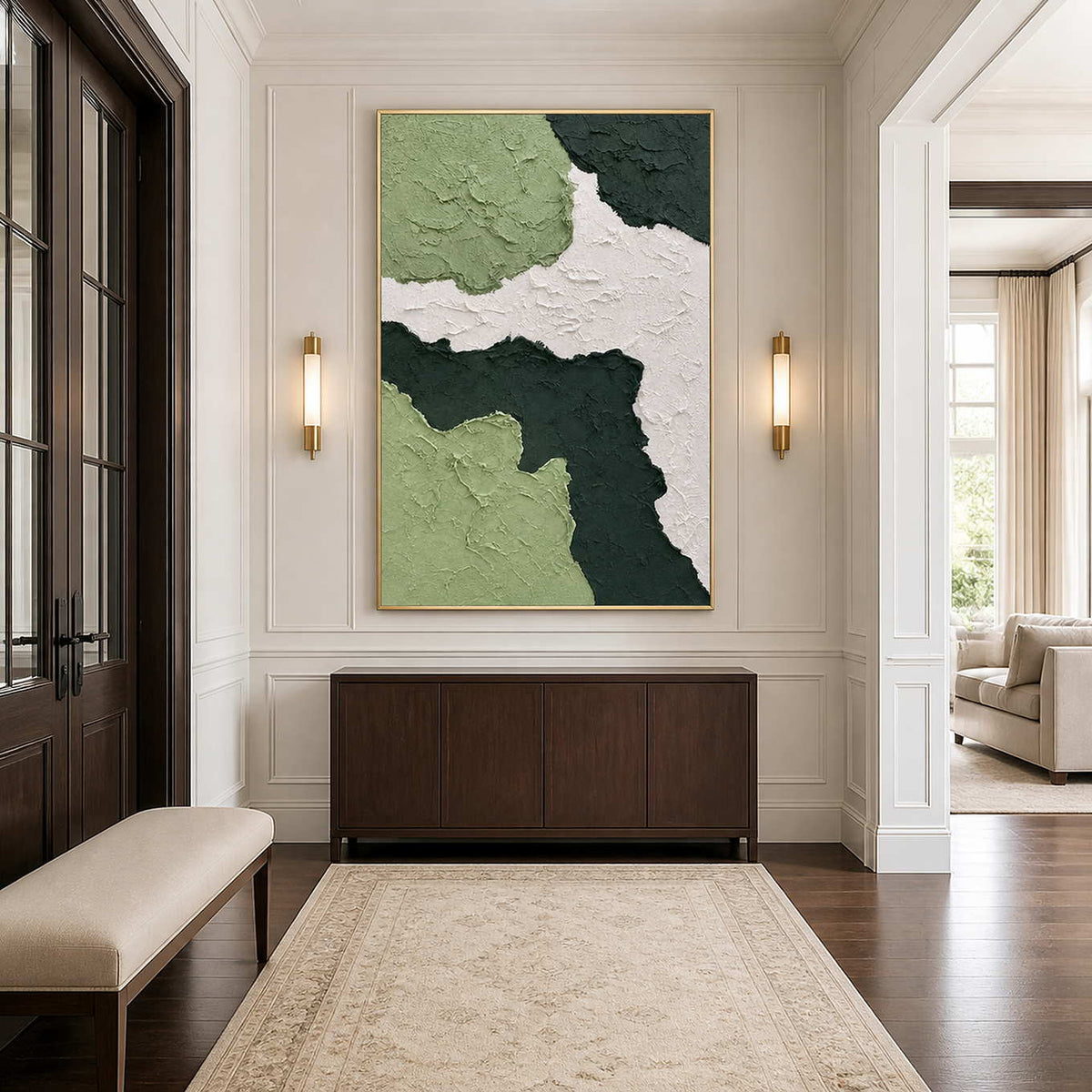 Gold framed green abstract painting above a walnut console in a paneled entryway.