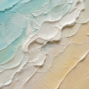 Close-up of blue-green waves meeting warm white sand texture.