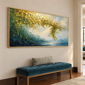 Golden foliage and misty blue water landscape painting in a gold frame in a hallway.