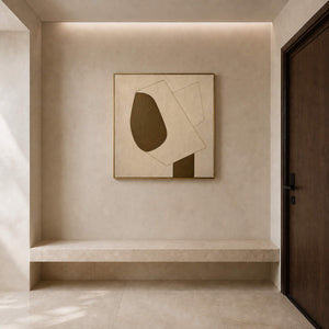 Square geometric wall art displayed in a limestone entryway.