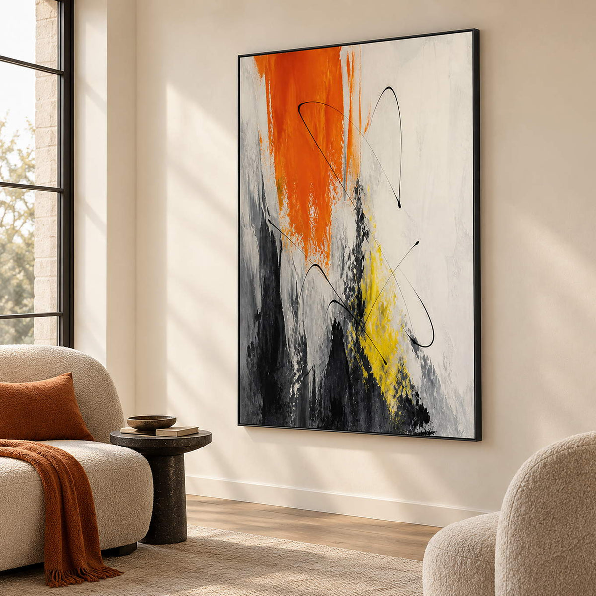 Vertical abstract artwork in orange, black, white, charcoal, and yellow, displayed in a lounge in a black frame.