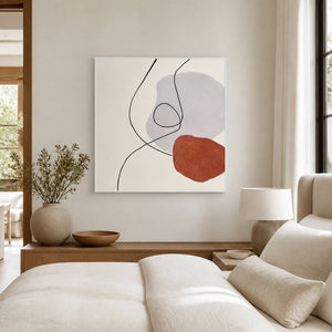 Light-framed line artwork beside a cream bed and bedside lamp.