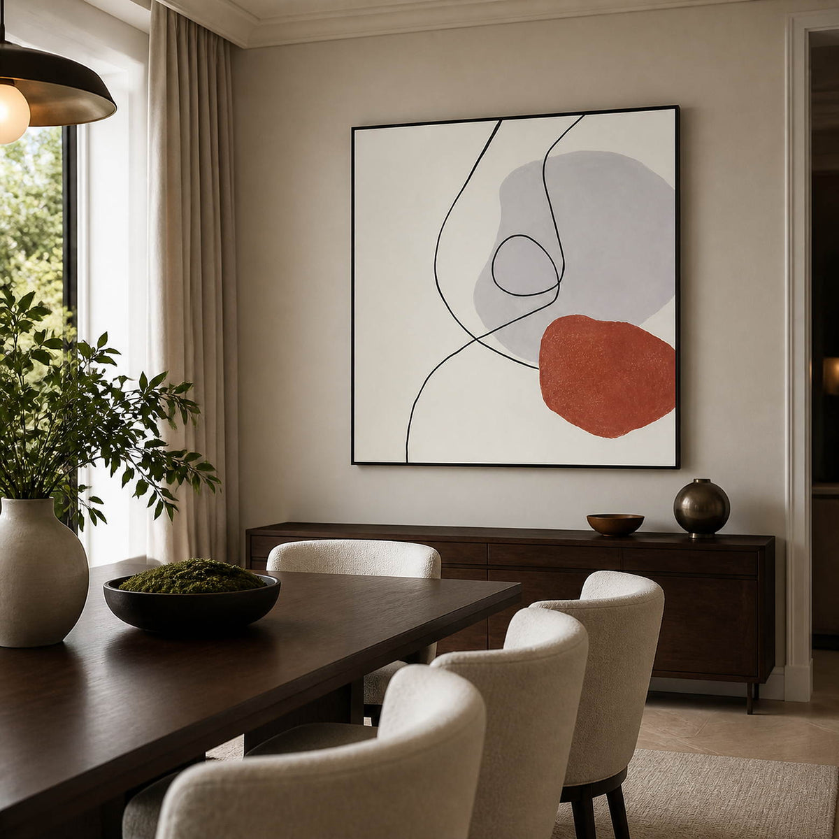 Gray-and-terracotta abstract artwork above a dining room sideboard.