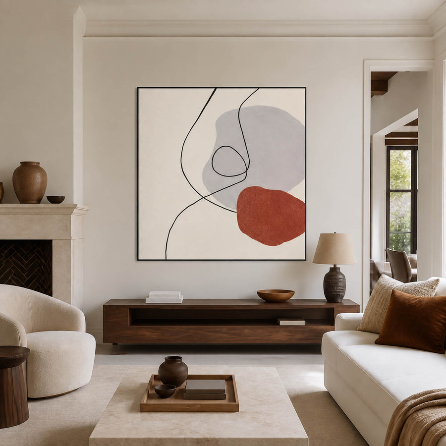 Minimalist line painting above a low console beside a fireplace.