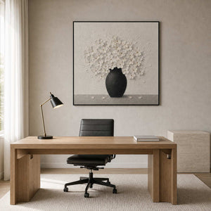 Textured white floral wall art displayed in a monochrome home office.