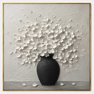 Textured white floral wall art with a matte black vase.
