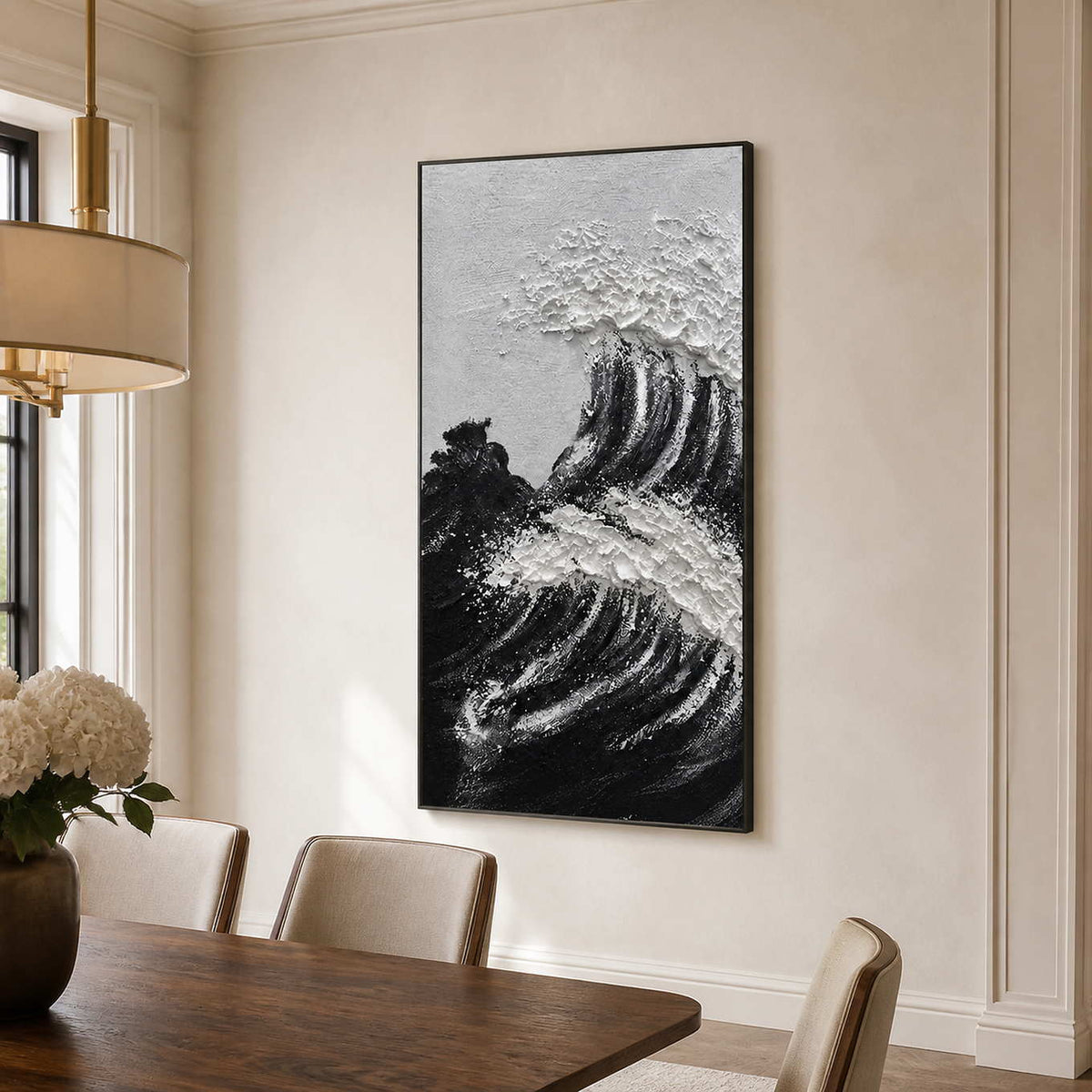 Black framed wave painting with raised white crests beside a wooden dining table.