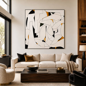 Cream geometric artwork above a pale sofa with dark cushions.
