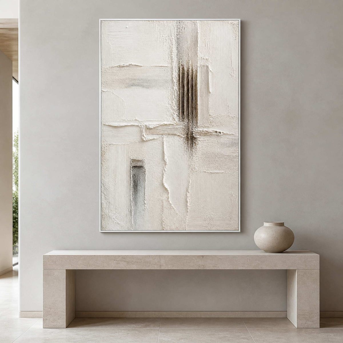 Sculpted ivory wall art above a pale stone entryway console.