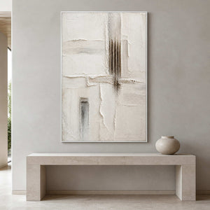 Sculpted ivory wall art above a pale stone entryway console.