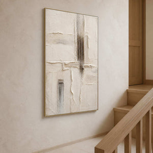 Tall neutral relief artwork displayed beside a light wood staircase.